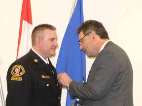 Bill Roth is presented with a Diamond Jubilee Medal by Vermilion-Lloydminster MLA Richard Starke Friday morning.