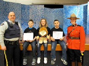 The RCMP constables who taught their D.A.R.E. (Drug Abuse Resistance Education) pose for a photo with the three Sangudo Community School Grade 6 students who made presentations at their graduation on Wednesday, March 13. They are, from left, Const. Shaun Provost, Calder Thompson (a news article), Daryka Kerr (a news article) Dawson Preston (an essay) and Const. Megan Olynek.