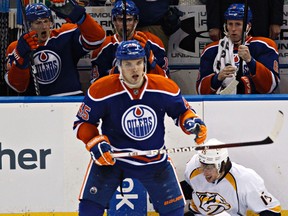 Oilers defgenceman Mark Fistric skates away as Predators’ Craig Smith recovers from being checked into the boards Sunday at Rexall Place. (Codie McLachlan, Edmonton Sun)