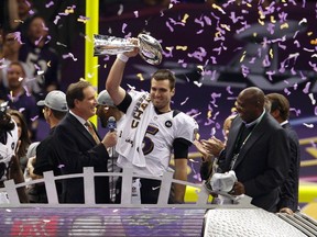 Baltimore Ravens quarterback Joe Flacco raises the Vince Lombardi Trophy as he celebrates beating the San Francisco 49ers in Super Bowl XLVII in New Orleans, Louisiana, February 3, 2013. (REUTERS/Jim Young)