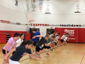 Members of the Father Mercredi Trappers rugby teams do fitness training at the Father Merc gymnasium Monday evening.  TREVOR HOWLETT/TODAY STAFF