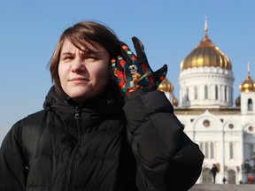 Yekaterina Samutsevich, a member of punk group Pussy Riot, looks on during an interview in front of the Christ the Saviour Cathedral in Moscow, February 21, 2013. (REUTERS/Sergei Karpukhin)