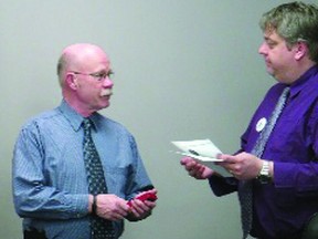 Councillor Terry Farden presents the medal to a surprised Mr Trann,
the current Town mayor.