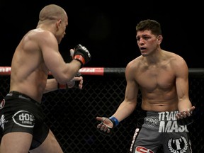 Nick Diaz taunts Georges St. Pierre during their title fight at UFC 158 Saturday, March 16, 2013 in Montreal. (MARTIN CHEVALIER/QMI Agency)