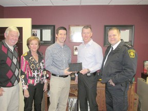 CMR, Hanover, made a special donation to the Hanover Police Service. From left: Danny Craig, owner of CMR; Melanie Craig owner; Mike Craig, CMR; constable Jeremy Mighton, Saugeen Shores police; and inspector Chris  Knoll, Hanover Police Service.