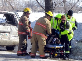 The occupant of a vehicle is loaded onto a stretcher following a two vehicle accident at Crescent Rd. and Portage Ave., Tuesday afternoon. The crash resulted in one occupant being sent to hospital. (ROBIN DUDGEON/PORTAGE DAILY GRAPHIC)