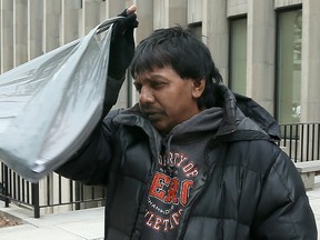 Mac Bool Hassan, convicted of abusing his stepdaughter , walks out of 361 University Ave. courts March 18, 2013. (Dave Abel/Toronto Sun)