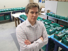 Ben Gooch, the affirmative business operations manager at the Voices Opportunities & Choices Employment Club on Montreal Street, which provides employment for people with mental illnesses, stands with the assembly line of brake pieces for Knorr Brake, now slowly shutting down because the plant is closing. (Michael Lea The Whig-Standard)