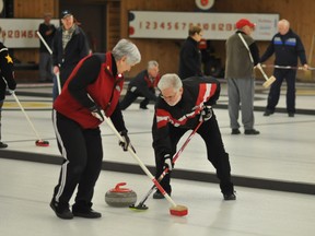Laura Steep and Norm Beaudry, of the Armand Boudreau rink, sweep following their team-mate’s delivery during a match against the Chuck Harrison squad at the McIntyre Curling Club Tuesday. The two rinks were among 14 competing in the Joe Gubbels Funspiel. The action continues Wednesday.