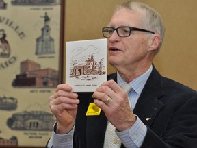 Doug Grant, a member of the Brockville Railway Tunnel Committee, holds up a ceramic coaster depicting the tunnel, an item that was in circulation in the 1960s, during city council's finance, administration and operations committee meeting Tuesday afternoon. RONALD ZAJAC The Recorder and Times