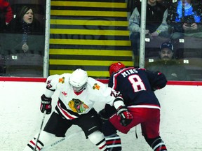 Brockville Braves' Brett Garvey battles for the puck along the boards with Cornwall's Andrew Ming during second-period Central Canada Hockey League playoff action Tuesday. (NICK GARDINER The Recorder and Times)