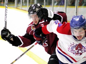 Chatham Maroons' Evan Mascaro, left, and Strathroy Rockets' Tyler Coleman fight for the puck at the West Middlesex Memorial Centre in Strathroy last season. The Rockets are opened their training camp Saturday.
(MIKE HENSEN/QMI Agency)