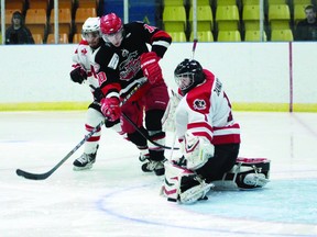 Nepean Raiders' goalie Matt Zawadzki comes to the top of the crease to make a save as Lumber Kings' forward Brendan McGuire looks for a rebound during third period action of game four in Nepean Tuesday night.