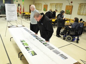 Whitewater Region Deputy Mayor Izett McBride, left, and Devlin Helferty peruse details of this summer’s proposed Highway 17 construction project at a public meeting at the Cobden Legion on Monday night. (QMI Agency photo)
