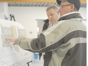 Town of Peace River Councillor Colin Needham (right) gains a better understanding of the concept plan from Town of Peace River Recreation and Facilities Co-ordinator Brian Wollis during an open house to gather feedback on a multi-use facility last year. The town is now looking at speeding up the process due to structural concerns with the Baytex Energy Centre.