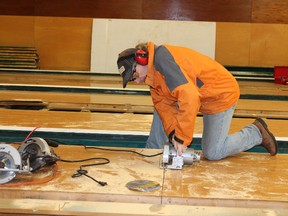 Trevor Walsh cuts up the lanes at Delaney Bowl for salvage. He plans to make harvest tables, benches and counter tops out of the 9,640 feet of fir, maple and tiger maple.
Emma Taylor for The Gananoque Reporter