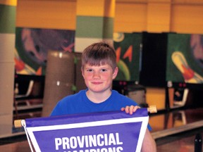 Kenora’s Daniel Blake holds up his Northern Ontario Provincial Championship banner at the Kenora Bowling Lanes. With the win Blake moves on to represent Northern Ontario at the Nationals in British Colombia in May.