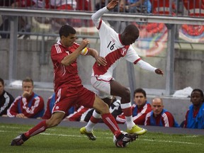 Canada's Paul Stalteri (left) battles against Peru's Luis Advincula during a friendly in Toronto on Sept. 4, 2010. (Adrien Veczan/Reuters/Files)