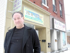 Stephen Hull stands in front of his and his wife's Pie in the Sky Cafe in Napanee. The cafe has been closed because the next door vacant portion of the building has partially collapsed and the town has cordonned off the whole area.