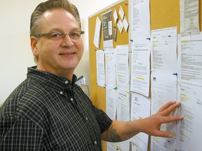 George Dunn, a peer helper at Steelworkers 4906 Job Action Centre, looks over employment postings at the centre, which held an open house on Wednesday. (Eric Bunnell, Times-Journal)