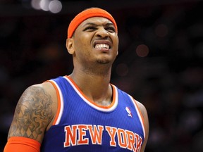 New York Knicks' Carmelo Anthony grimaces as he leaves the court after injuring himself when falling at midcourt during the second quarter of their NBA basketball game against the Cleveland Cavaliers in Cleveland March 4, 2013. (REUTERS/Aaron Josefczyk)