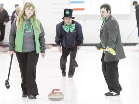 Ponoka’s Courtney, left, and Dylan Hor escort the rock down the ice while Larry Goodwin, centre, keeps a careful eye on his shot at the Town and Country Bonspiel in Wetaskiwin March 17.