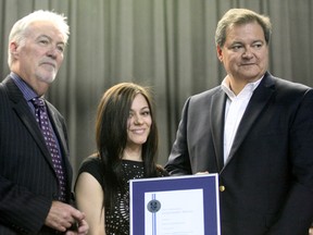 Former Nipissing University president Dave Marshall, left, and current president Mike Degagne, presented Nipissing University Student Union vice-president internal Kayla Fitzsimmons with a leadership award during a ceremony Wednesday. (MARIA CALABRESE The Nugget)