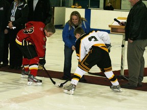 Cheryl Lyman of Investors Group drops the puck for the official start of the Alberta Atom B Provincials in Fairview on March 15 with Cache Schiller of the Westlock Warriors (left) facing off against Jaden Schultz of the Fairview Fentie’s UFA Jr. Kings.