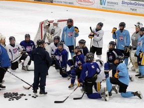 The Junior Oil Barons listen to coaches Dale Denoncourt and Randy Macnab at their last practice Wednesday evening at the Casman Centre.   TREVOR HOWLETT/TODAY STAFF