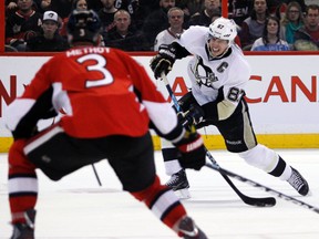 Ottawa Senators' Marc Methot (3) watches a shot by Pittsburgh Penguins Sydney Crosby (87) during the second period of NHL hockey action at Scotiabank Place in Kanata, Sunday Jan. 27, 2013.  Darren Brown/Ottawa Sun/QMI Agency)