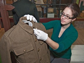BRIAN THOMPSON, The Expositor

Chelsea Carrs, curator of the Brant Museum and Archives, prepares a First World War service uniform worn by Henry Clubine of the 44th Division that is part of the We Are What We Wore exhibit that opens Thursday.