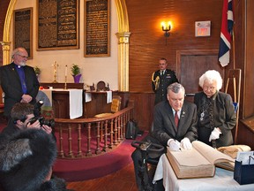 BRIAN THOMPSON, The Expositor

Leona Moses, former curator of Her Majesty's Royal Chapel of the Mohawks, watches as Ontario Lt.-Gov. David Onley signs the Queen Anne bible on Wednesday.  Onley officially opened the accessibility project, which saw construction of a small addition to houses an elevator.