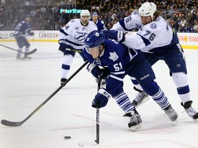 Jake Gardiner of the Toronto Maple Leafs gets away from Pierre-Cedric Labrie of the Tampa Bay Lightning during NHL hockey action at the Air Canada Centre in Toronto March 20, 2013. (DAVE ABEL/Toronto Sun)