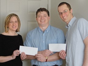 Paul Barker, centre, presents cheques of $4,300 ea. to Kim Williams-Lowe and Dylan Oostervald.