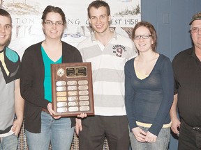 Trenton Curling Club Mixed Skins Bonspiel organizer Neil Harder (right) presents 'A' championship trophy to Peterborough Curling Clubís Adam Gagne (skip), Lana Shapton (vice), Trevor Brewer (second), Jessica Brewer (lead) Sunday at TCC.