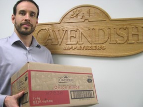 Kerry Coolen, director of operations for Cavendish Appetizers, hoists a box of frozen onion rings, which commands most of the production at the Wheatley food processing facility. Cavendish Appetizers is the Industry of the Month for the Chatham-Kent Chamber of Commerce. (PETER EPP, QMI Agency)