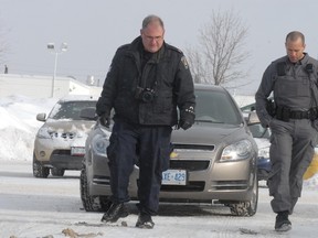 City police check the parking lot at Cambrian Mall following a robbery at TD Canada Trust on Wednesday, March 20, 2013.