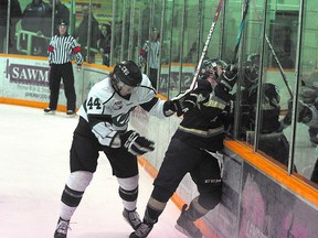 Crusader Cody Bardock pastes Saint Tim Nolte to the boards during Monday’s 6-5 loss in double overtime. The Cru bounced back on Wednesday to win Game 5 by a 2-1 score and force their AJHL playoff series to continue. Photo by Shane Jones/Sherwood Park News/QMI Agency