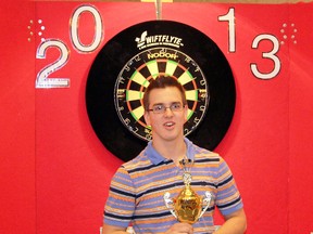 CONTRIBUTED PHOTO
Simcoe’s Daniel Eynon, 19, holds the trophy he won for coming in second in the Ontario senior boys darts finals held in St. Catharines earlier this year. Eynon advanced to the nationals in Newfoundland this past May but did not win. Eynon loved the competition and wants to return in the future.