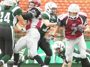 Mallory Starkey of the Regina Riot (right) breaks through the line for a gain during a Western Women’s Canadian Football League game against the Saskatoon Valkyries last summer. (Photo courtesy Adrienne Zuck/Regina Riot)