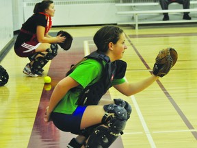 Sam Turner prepares to catch a pitch during PCI Saints fast-pitch tryouts on Wednesday. (Kevin Hirschfield/PORTAGE DAILY GRAPHIC/QMI AGENCY)