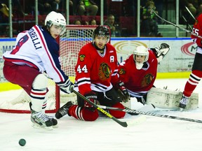 Brockville Braves defenceman Kevin Kirisits and goalie Andrew Pikul defend the Braves' net while Cornwall Colts foward Michael Pontarelli eyes a bouncing puck during game five of their CCHL opening-round playoff series Thursday night in Cornwall. (ROBERT LEFEBVRE Ice Level Action Photography)