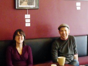 Jaclyn Frankum, exhibit organizer, and Jon Hepplewhite, owner of Rabbit Dash, relax after putting up art for the SDSS student art show at the coffee shop.