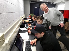 The Oil Kings education advisor Roger Castle works with players during a break after practice. (Perry Mah, Edmonton Sun)