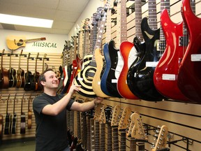 : JOHN LAPPA The Sudbury Star Justin Lalonde, of Hock Shop Canada on Lasalle Boulevard, puts an electric guitar back in place on Friday. The BEAR unit is the pawn shop's first point of contact with the police. Jeff Hobbs, the Hock Shop's regional manager, would like to see people who bring stolen items into the store charged with fraud.