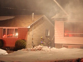 Greater Sudbury firefighters work to put out a fire on Hawthorne Drive in New Sudbury late Friday night. The blaze caused an estimated $350,000 in damage. JOHN LAPPA/THE SUDBURY STAR/QMI AGENCY