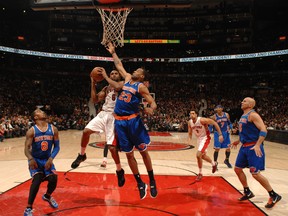The Raptors' Alan Anderson goes to the basket against Marcus Camby of the New York Knicks on Friday at the Air Canada Centre. (Getty Images/AFP)