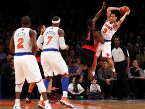 New York Knicks point guard Pablo Prigioni looks to pass defended by Toronto Raptors guard Terrence Ross in New York on Saturday.  (REUTERS/Adam Hunger)