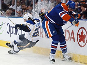 Edmonton's Ryan Smyth and Kevin Shattenkirk of St. Louis raise up some ice (Codie McLachlan, Edmonton Sun).
