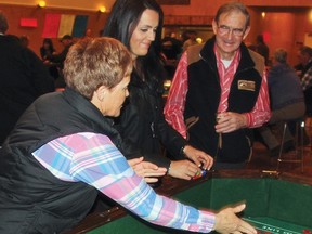Deb Tharle, from Mossleigh, tries out her luck at the craps table March 23 during the annual Mossleigh Lions Fun Casino. The event serves as the Lions main fundraiser of the year, and helps to cover the costs of maintaining the Lions Park and Campground, the camp kitchen and the ball diamond, said Mossleigh Lions president Ralph Wiebe.